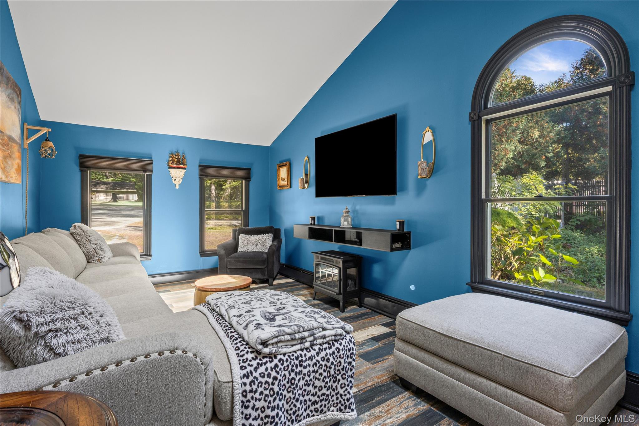 4 Model Court Rocky Point, NY 11778 - Photo 17 of 36 a bedroom with a large window and a flat screen tv