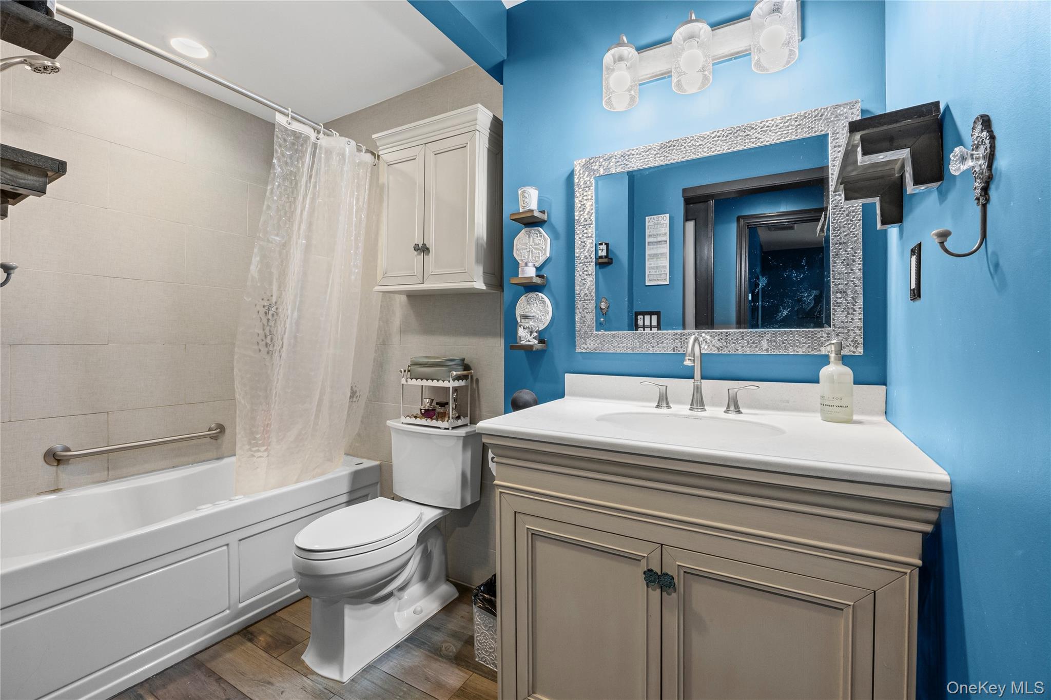4 Model Court Rocky Point, NY 11778 - Photo 28 of 36 a bathroom with a sink a toilet and shower