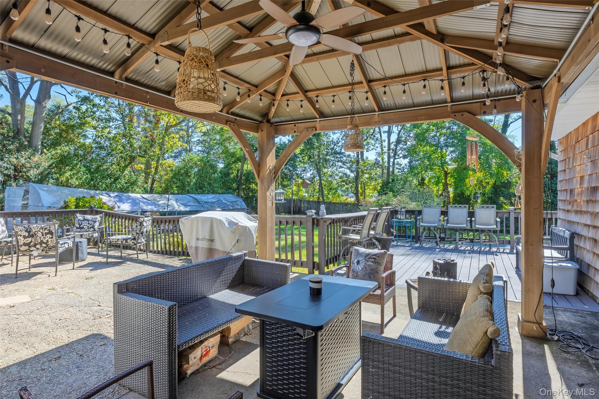 4 Model Court Rocky Point, NY 11778 - Photo 31 of 36 a view of a patio with a table chairs and a backyard