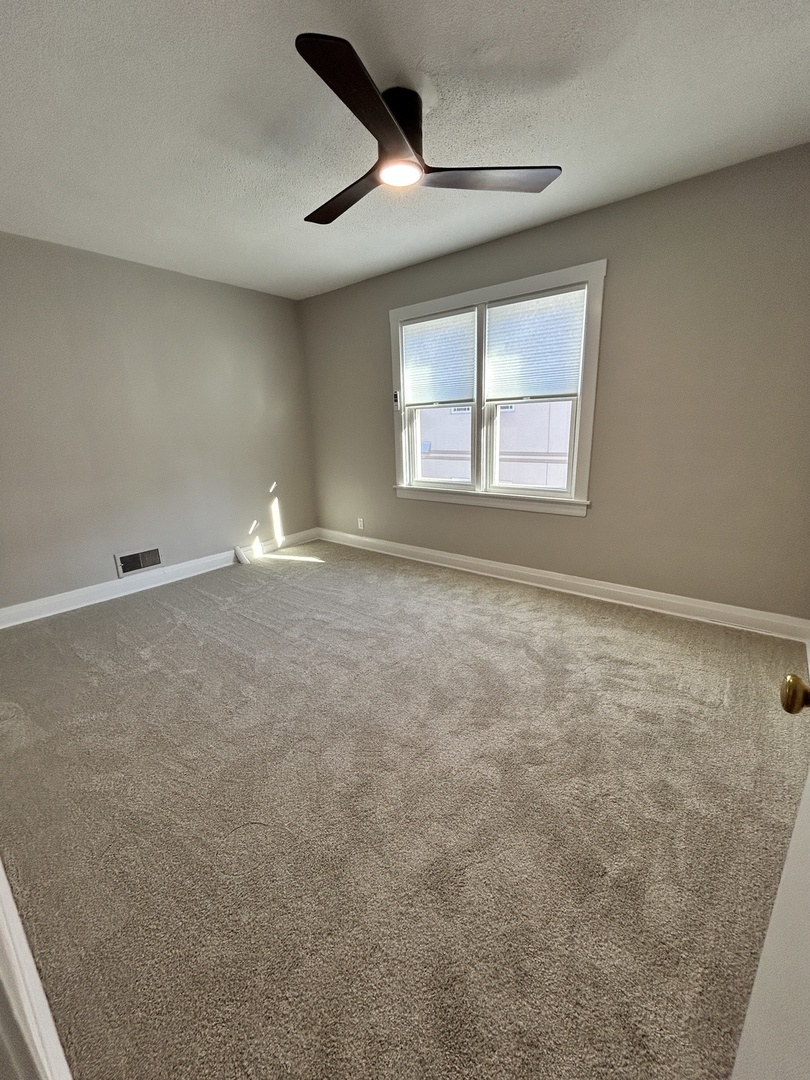 461 North Northwest Highway, Unit 2 Park Ridge, IL 60068 - Photo 5 of 17 a view of an empty room with a window