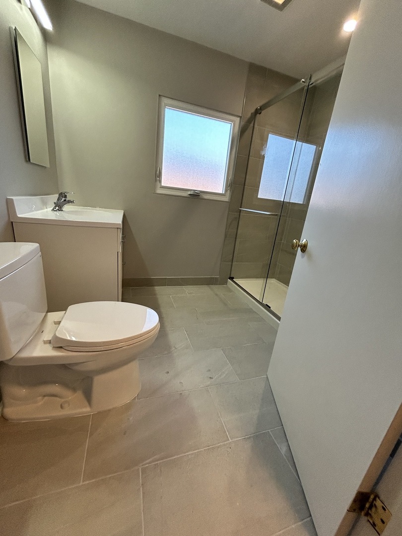 461 North Northwest Highway, Unit 2 Park Ridge, IL 60068 - Photo 9 of 17 a bathroom with a toilet and a mirror