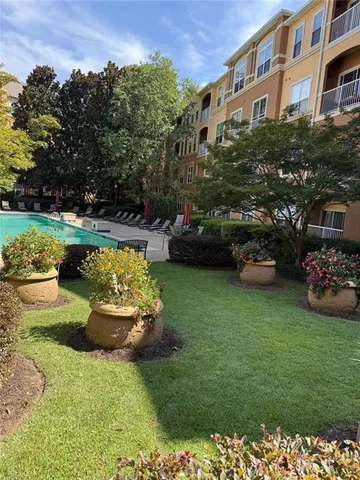 a front view of a house with a garden and seating area