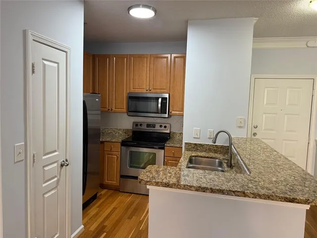 a kitchen with a sink a stove and cabinets