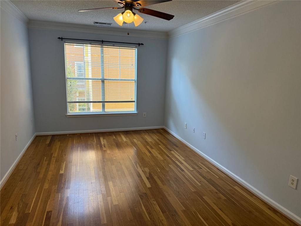 10 Perimeter Summit Boulevard, Unit 3201 Brookhaven, GA 30319 - Photo 7 of 27 an empty room with wooden floor and windows