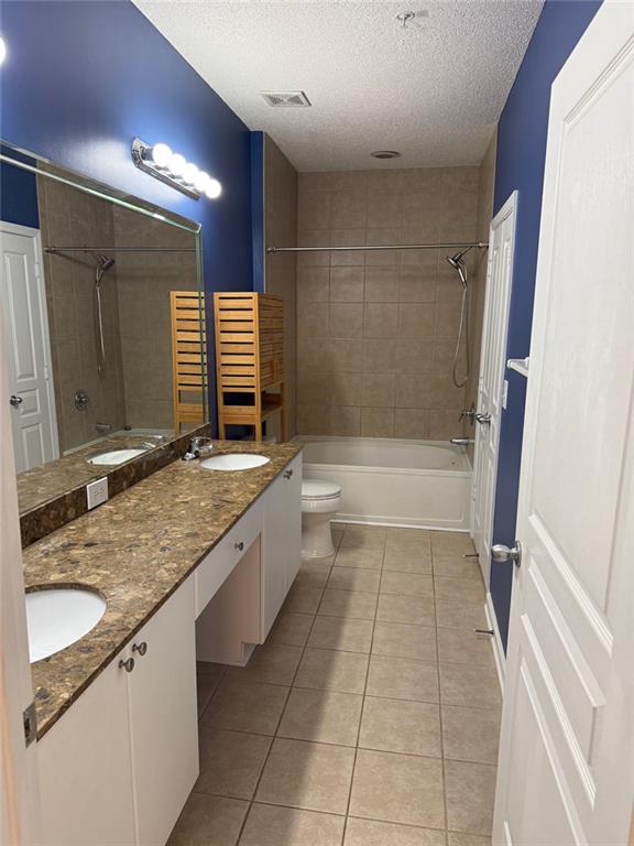 10 Perimeter Summit Boulevard, Unit 3201 Brookhaven, GA 30319 - Photo 9 of 27 a bathroom with a granite countertop sink a toilet and bathtub