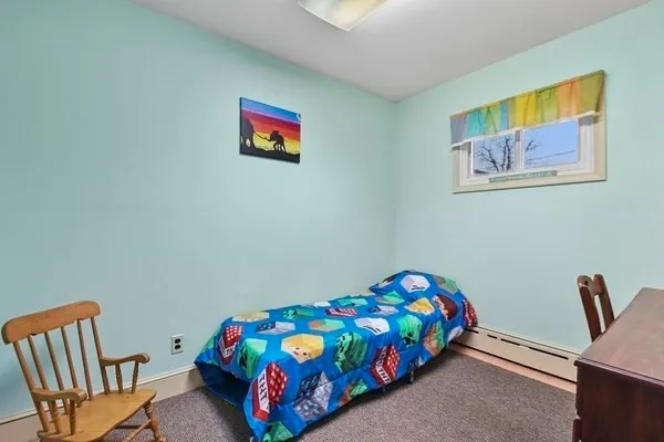 a bedroom with a bed and a chair in it