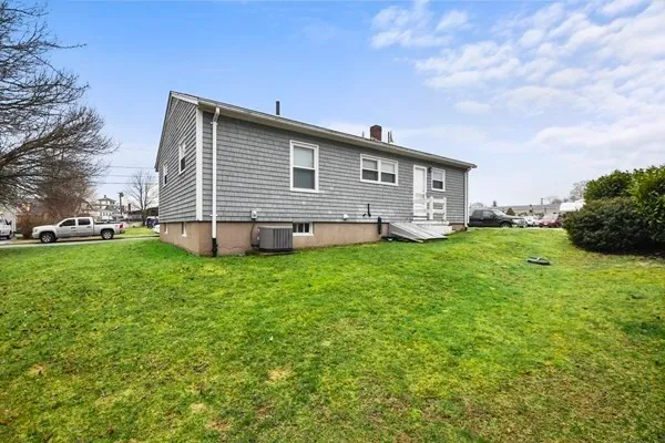 a view of a backyard with plants and large trees