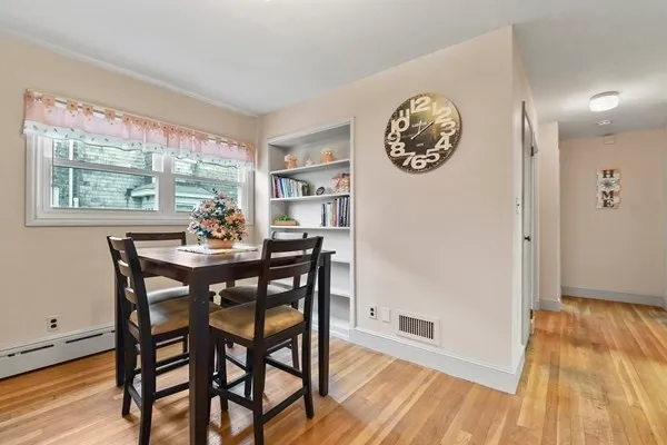 a dining room with furniture and a window