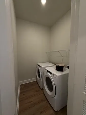 a spacious bathroom with a double vanity sink a toilet and a shower