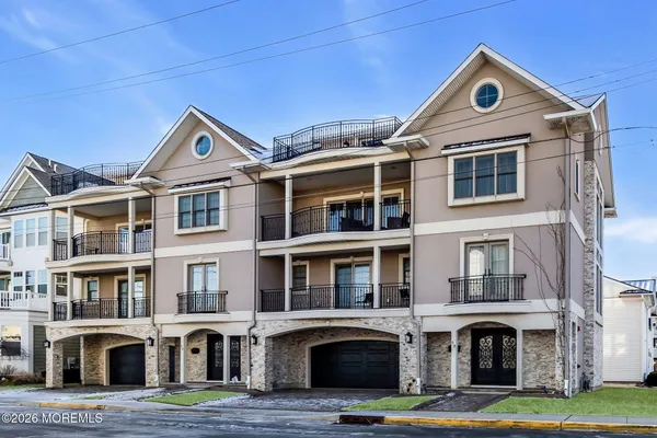 a front view of a residential apartment building with a yard