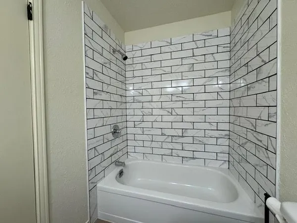 a bathroom with a shower and a bathtub