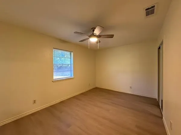 a view of an empty room with a fan