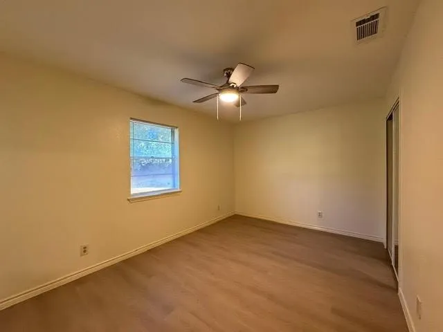 a view of an empty room with a fan