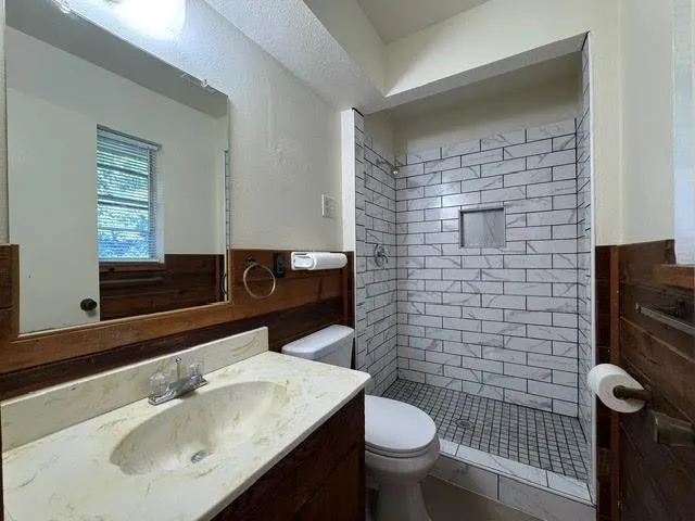 a bathroom with a sink toilet and mirror