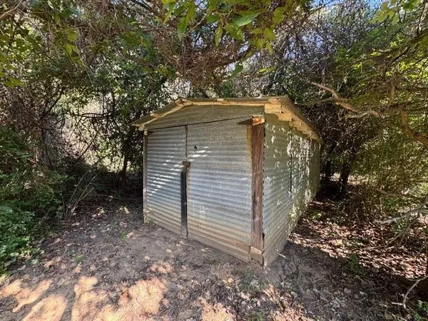 a yellow house with trees in front of it