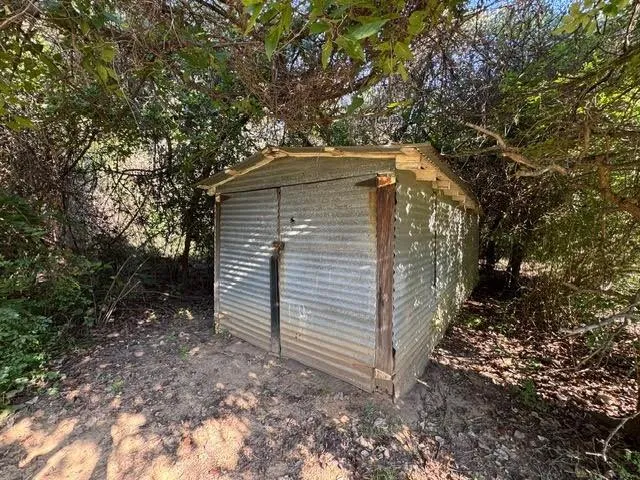 a yellow house with trees in front of it