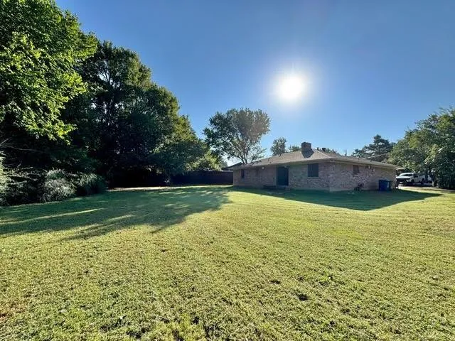 a view of a pool with a yard
