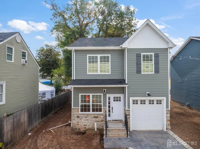 a view of a house with a yard and garage