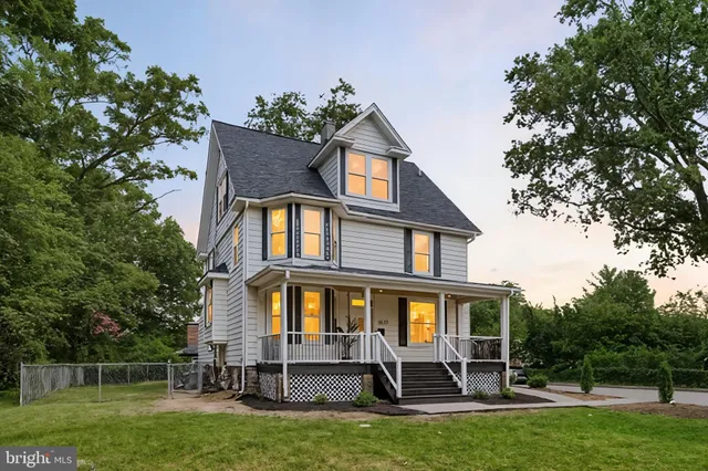 a front view of a house with a yard table and chairs