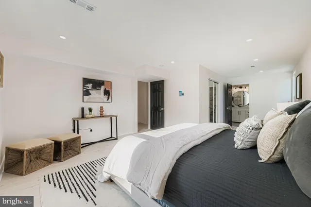 a bedroom with a bed a couch and a window