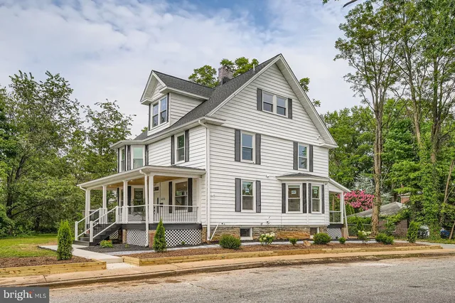 a front view of a house with a yard table and chairs