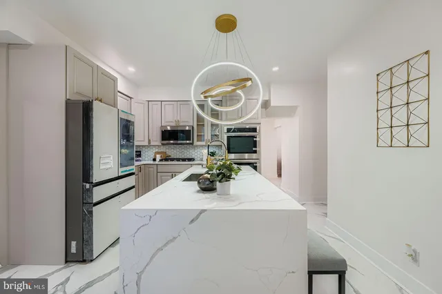 a kitchen with a sink and a stove with wooden floor