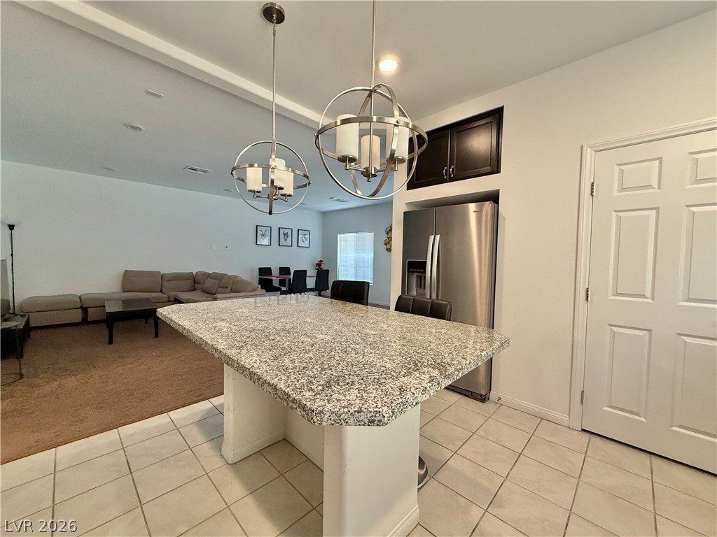 7777 South Westwind Road Las Vegas, NV 89139 - Photo 30 of 46 An inviting open-concept layout connects the kitchen island to the living area, perfect for entertaining.