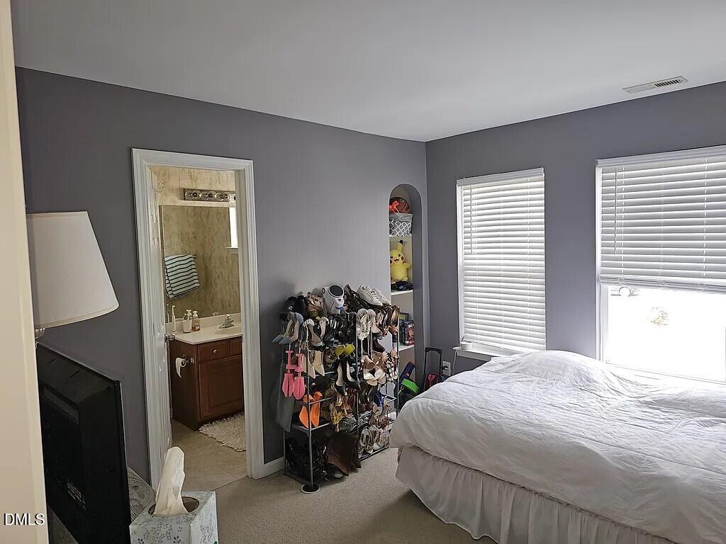 4602 Peyton Hall Way Raleigh, NC 27604 - Photo 13 of 17 a bedroom with a bed and a window