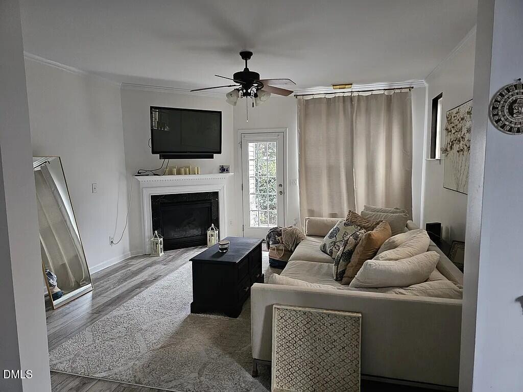 4602 Peyton Hall Way Raleigh, NC 27604 - Photo 3 of 17 a living room with furniture a flat screen tv and a fireplace