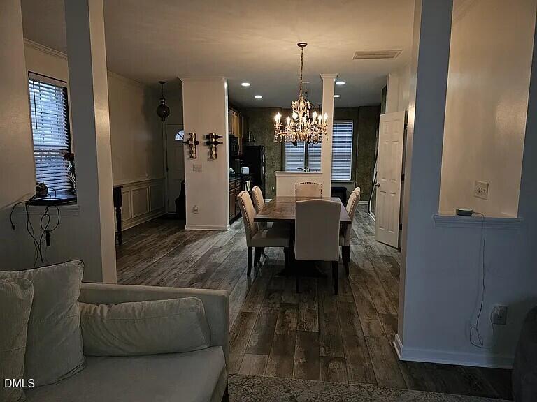 4602 Peyton Hall Way Raleigh, NC 27604 - Photo 5 of 17 a view of a dining room with furniture and wooden floor
