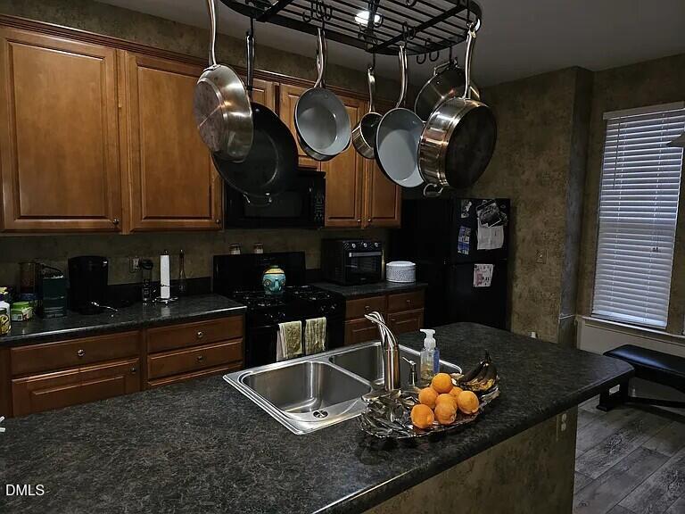 4602 Peyton Hall Way Raleigh, NC 27604 - Photo 7 of 17 a kitchen with blue cabinets and a sink