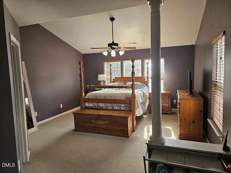 4602 Peyton Hall Way Raleigh, NC 27604 - Photo 8 of 17 a bedroom with a bed and a chandelier