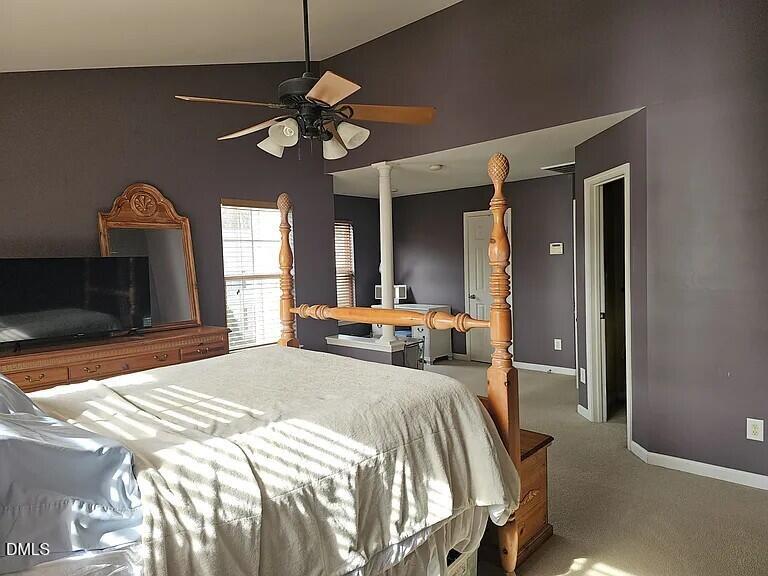 4602 Peyton Hall Way Raleigh, NC 27604 - Photo 9 of 17 a bedroom with a bed mirror and a chandelier