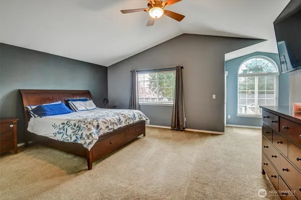 a bedroom with a bed and a television