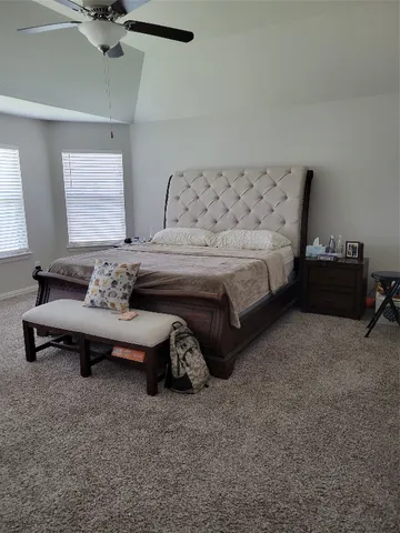 a bedroom with furniture and window