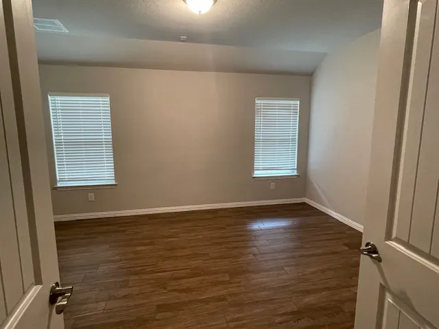 a bathroom with a granite countertop sink a toilet and shower