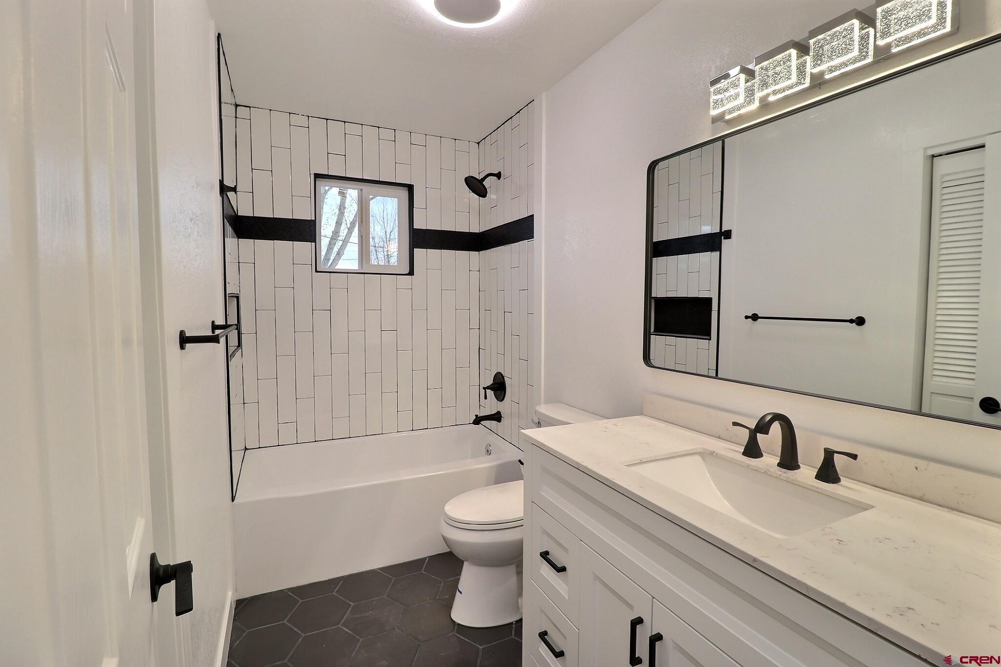 525 Sloan Street Delta, CO 81416 - Photo 11 of 26 a bathroom with a sink toilet tub and shower