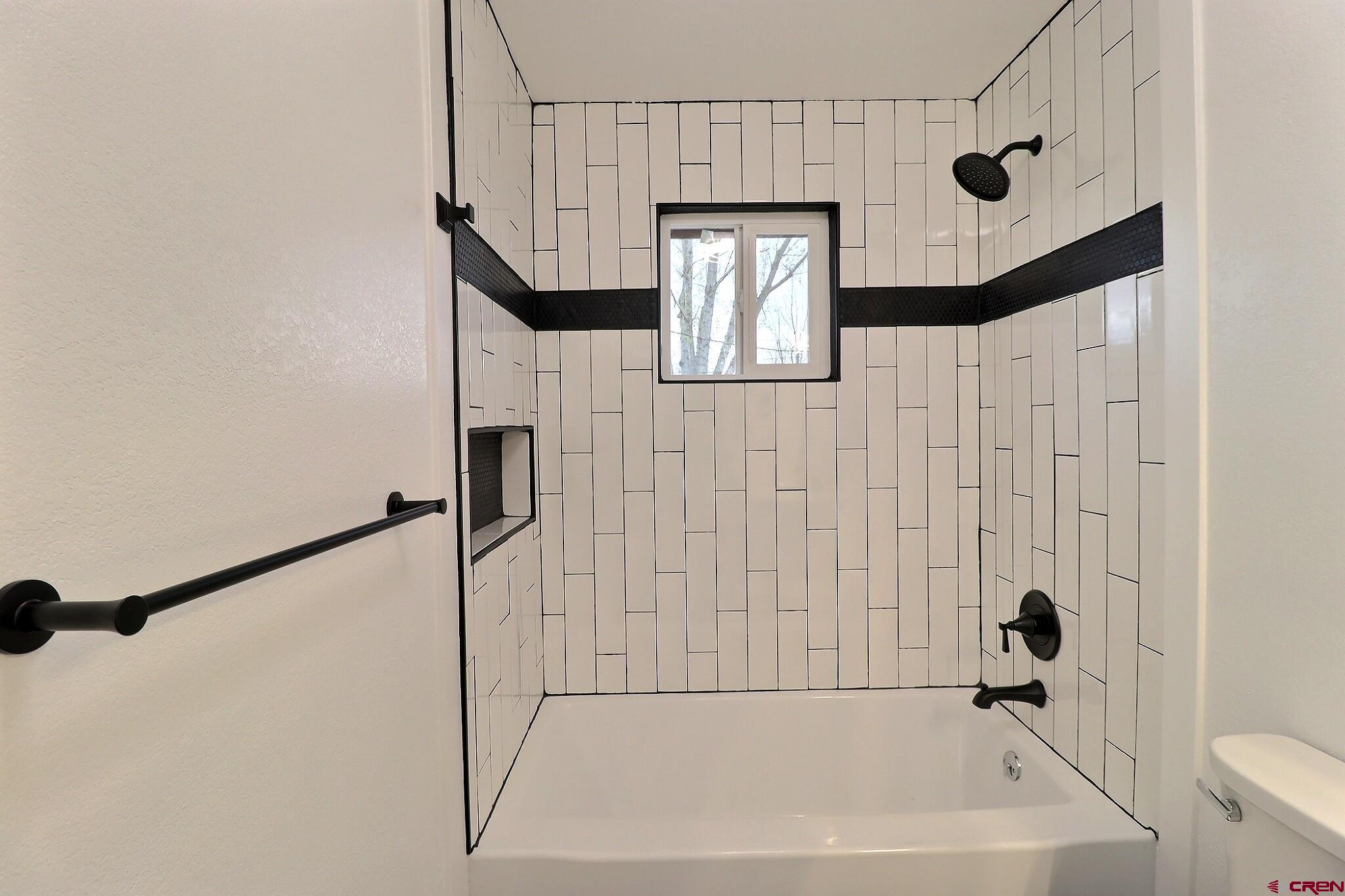 525 Sloan Street Delta, CO 81416 - Photo 12 of 26 a bathroom with a bathtub and a shower