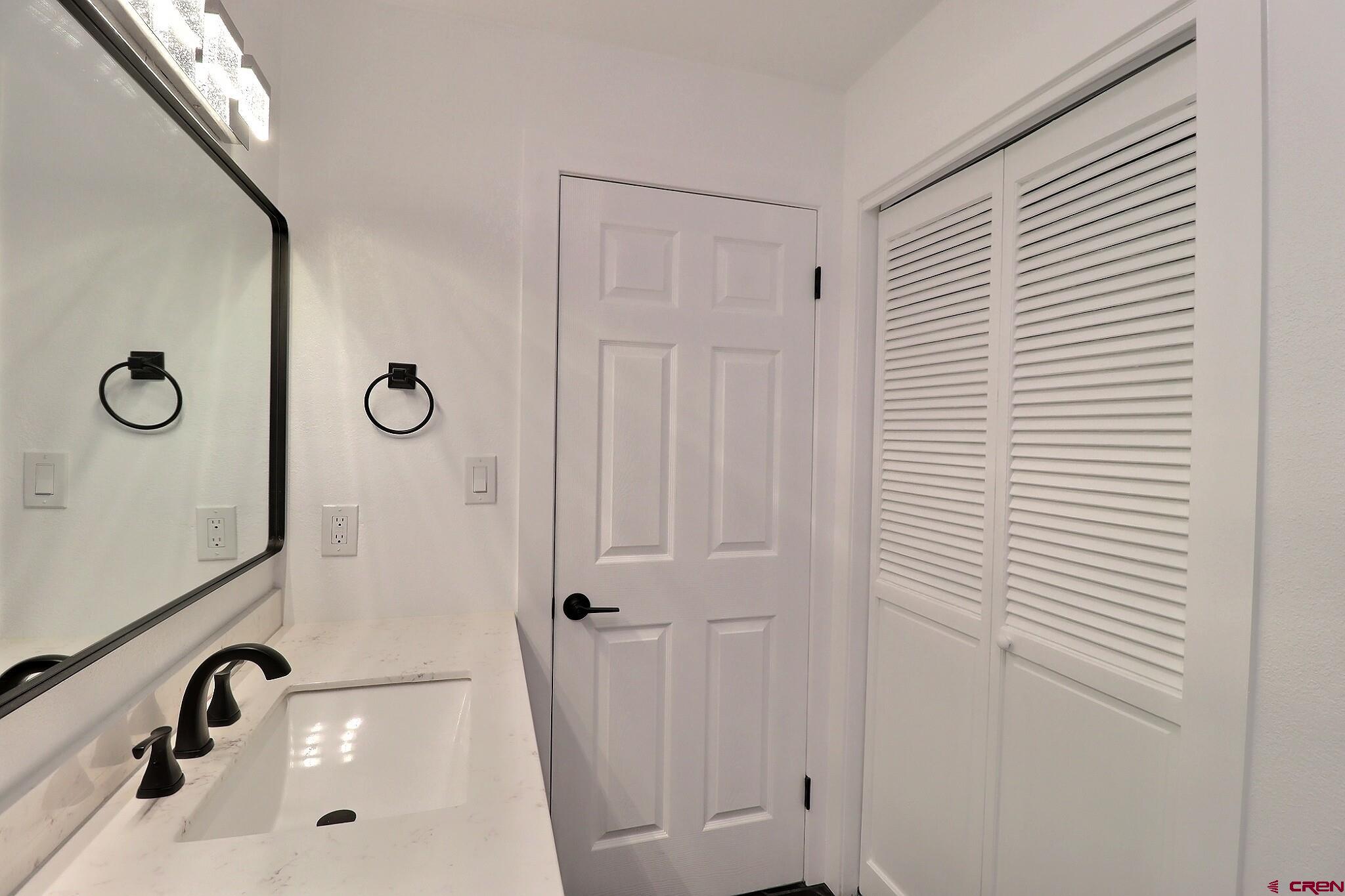 525 Sloan Street Delta, CO 81416 - Photo 13 of 26 a bathroom with a sink and a mirror