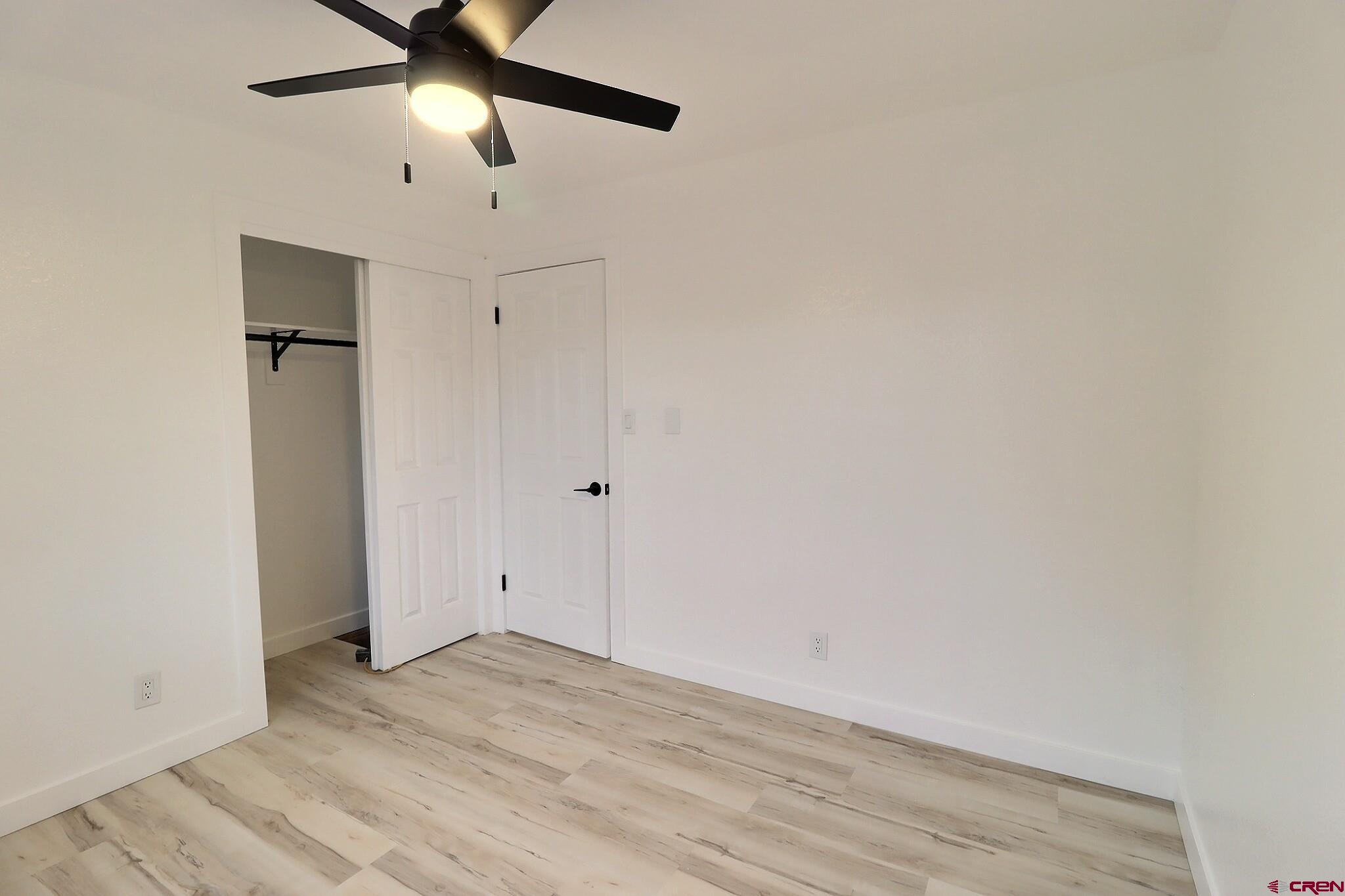 525 Sloan Street Delta, CO 81416 - Photo 14 of 26 a view of empty room with wooden floor and fan
