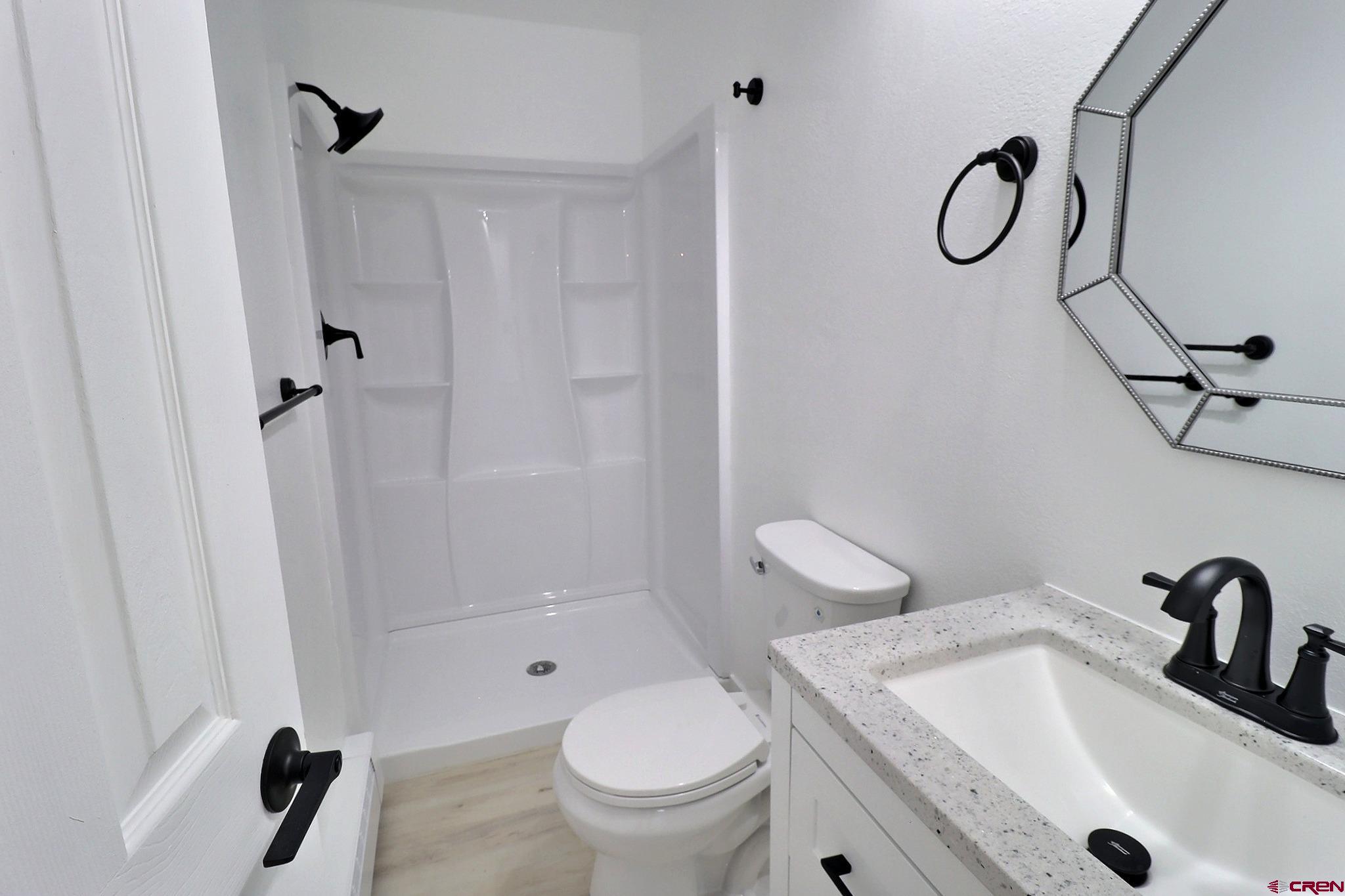 525 Sloan Street Delta, CO 81416 - Photo 18 of 26 a bathroom with a sink a toilet and a shower