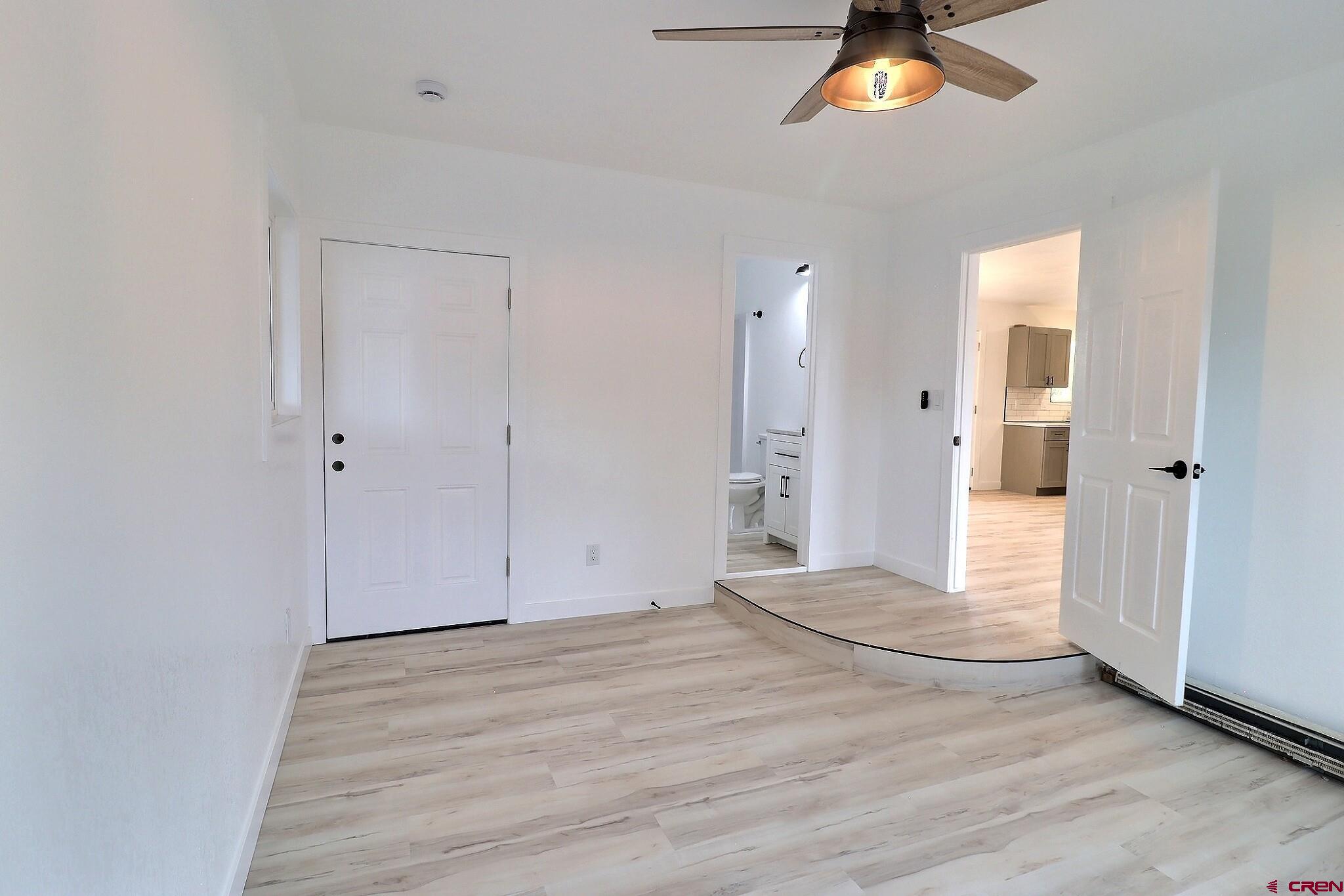 525 Sloan Street Delta, CO 81416 - Photo 19 of 26 a view of an empty room with chandelier fan and wooden floor