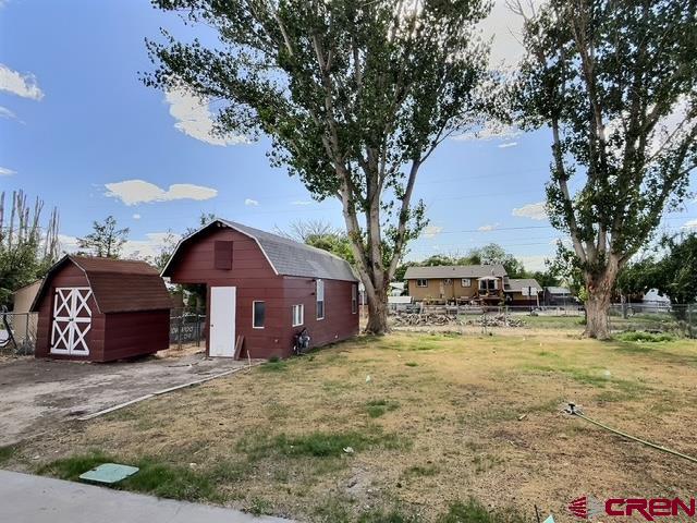 525 Sloan Street Delta, CO 81416 - Photo 23 of 26 a view of a house with a yard