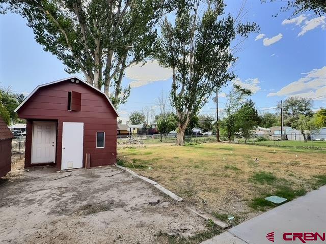525 Sloan Street Delta, CO 81416 - Photo 24 of 26 a view of a yard in front of a house with large trees
