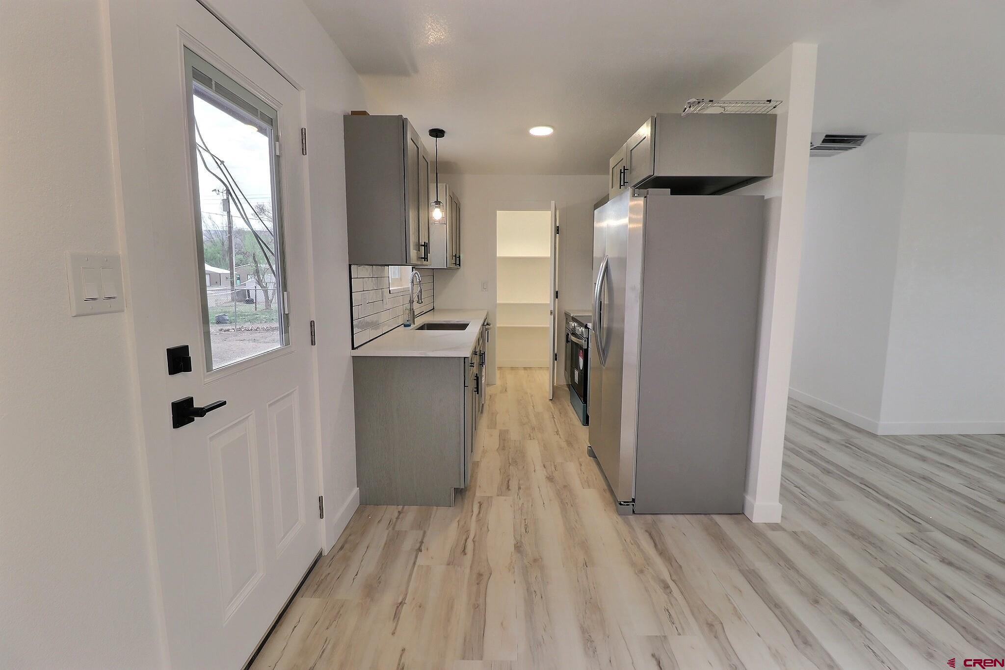 525 Sloan Street Delta, CO 81416 - Photo 5 of 26 a view of a kitchen from the hallway