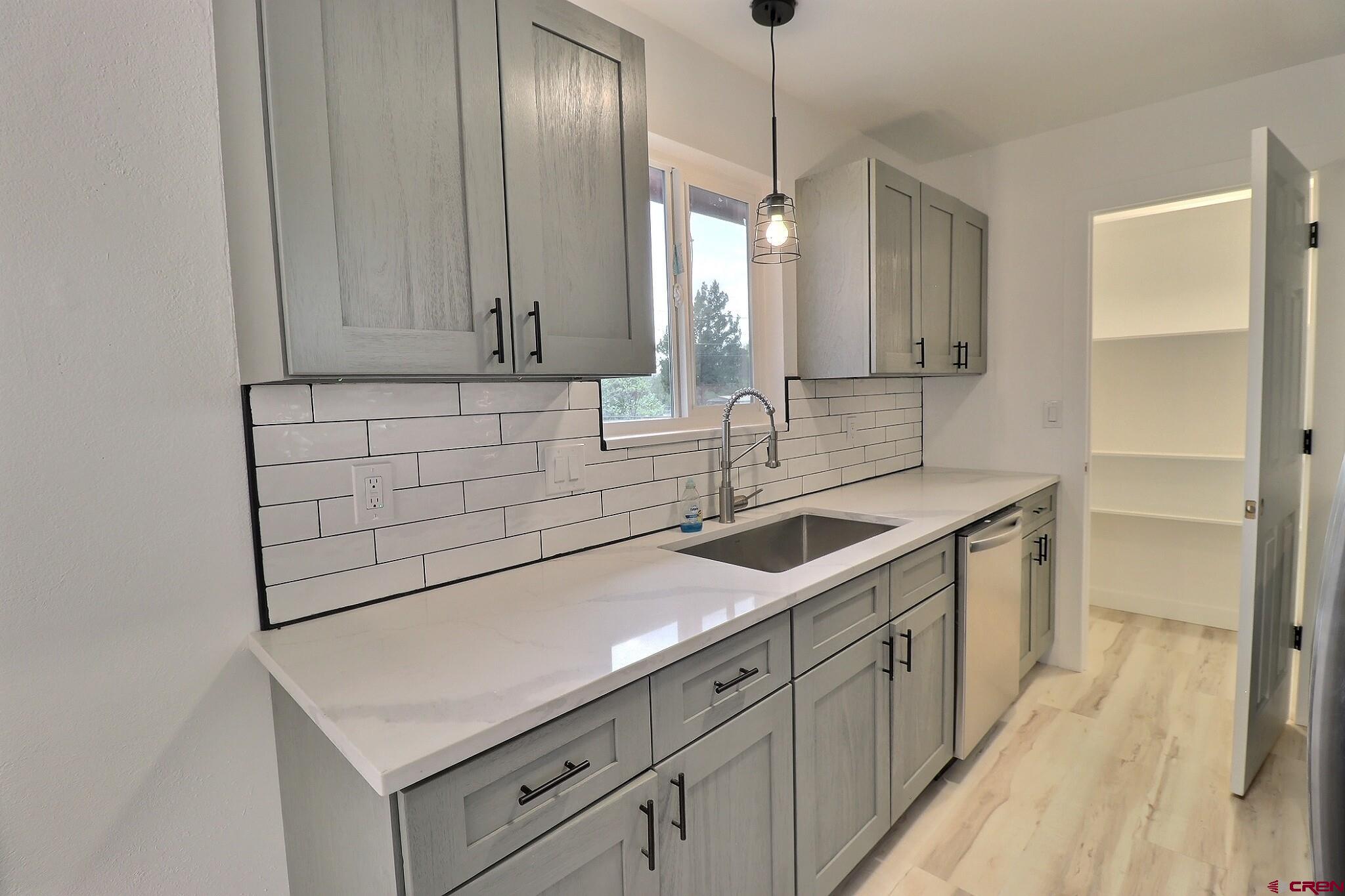525 Sloan Street Delta, CO 81416 - Photo 6 of 26 a kitchen with a sink and cabinets