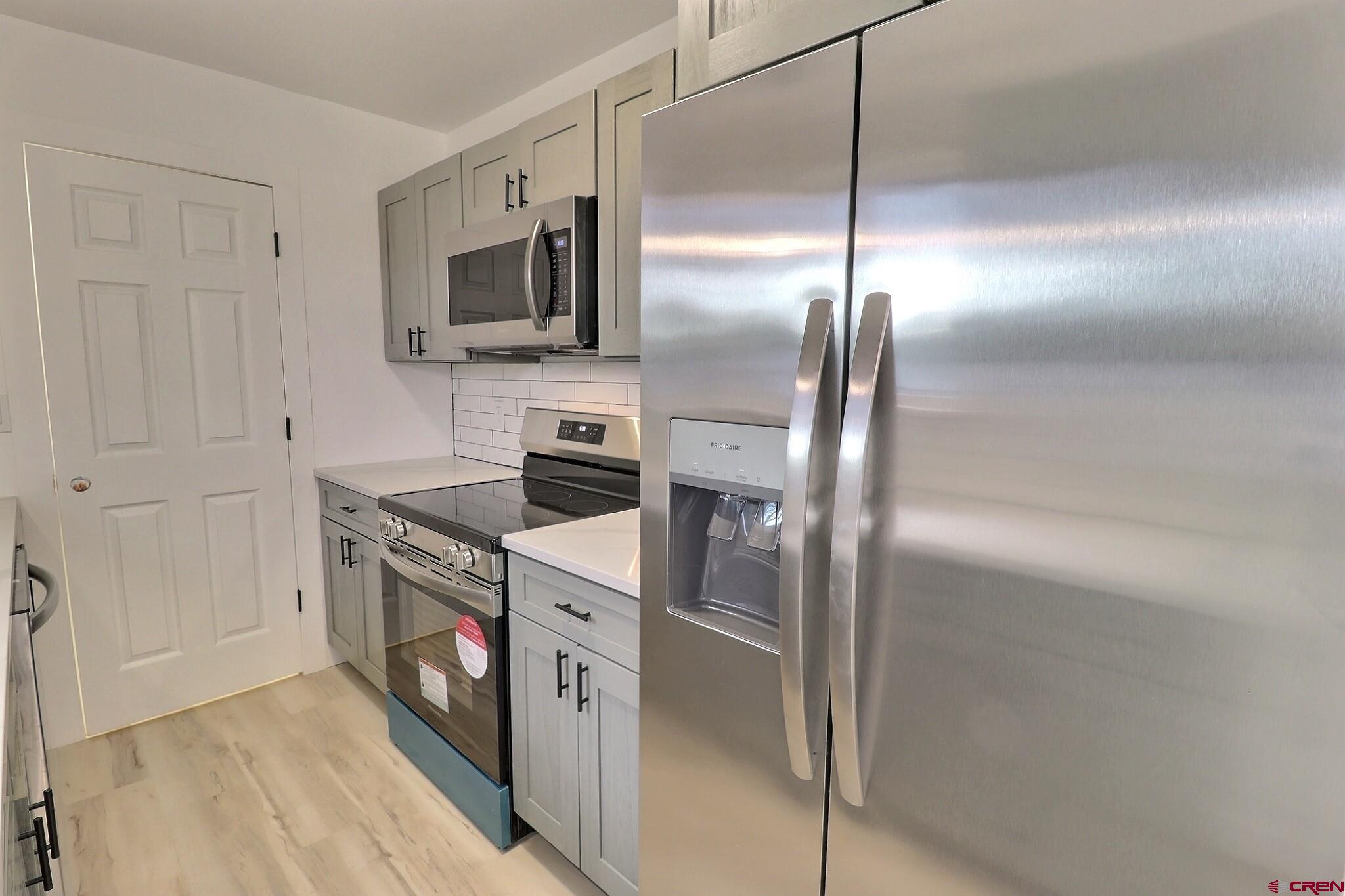 525 Sloan Street Delta, CO 81416 - Photo 7 of 26 a kitchen with stainless steel appliances granite countertop a refrigerator and a sink