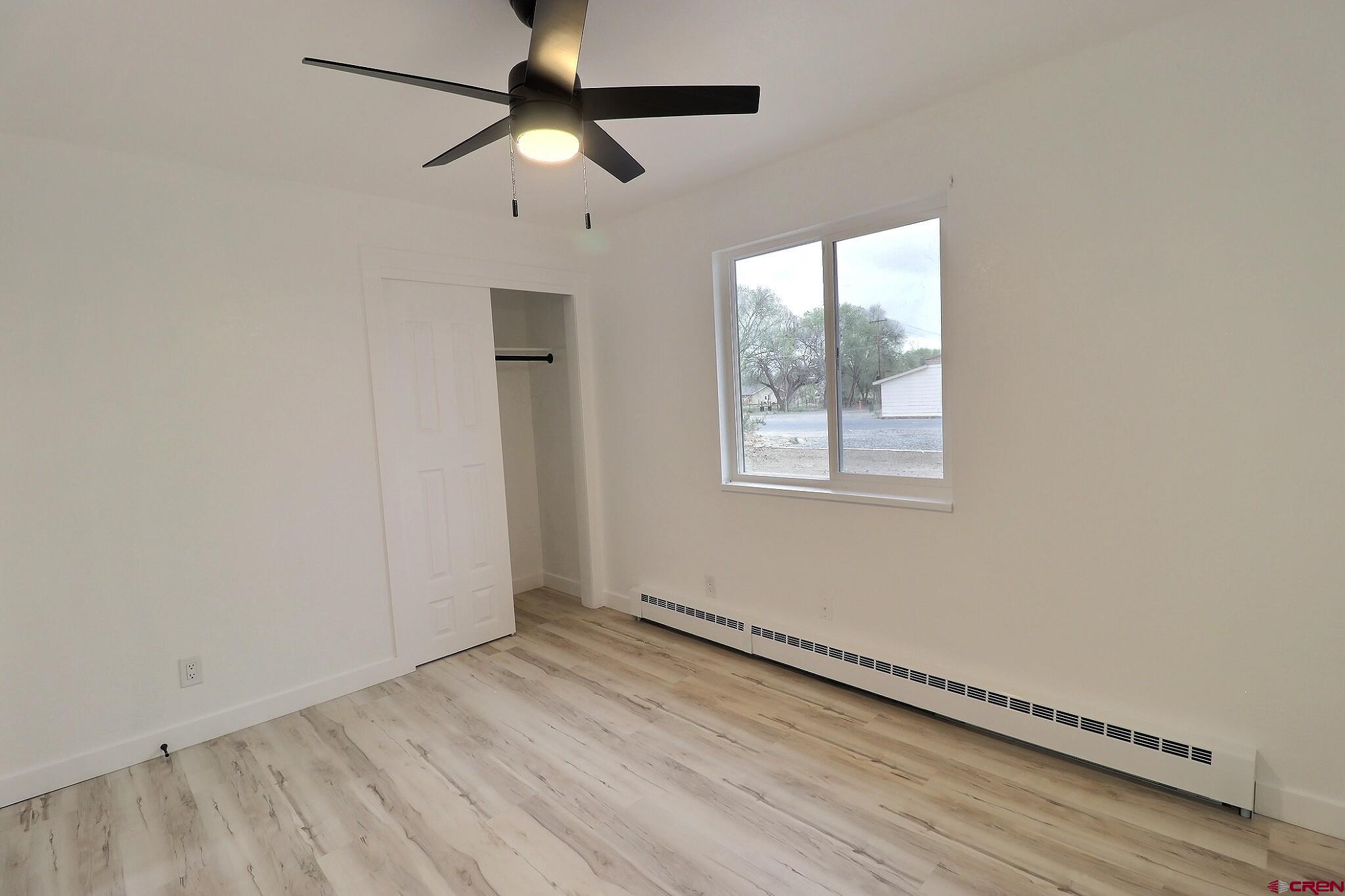 525 Sloan Street Delta, CO 81416 - Photo 10 of 26 wooden floor in an empty room with a window