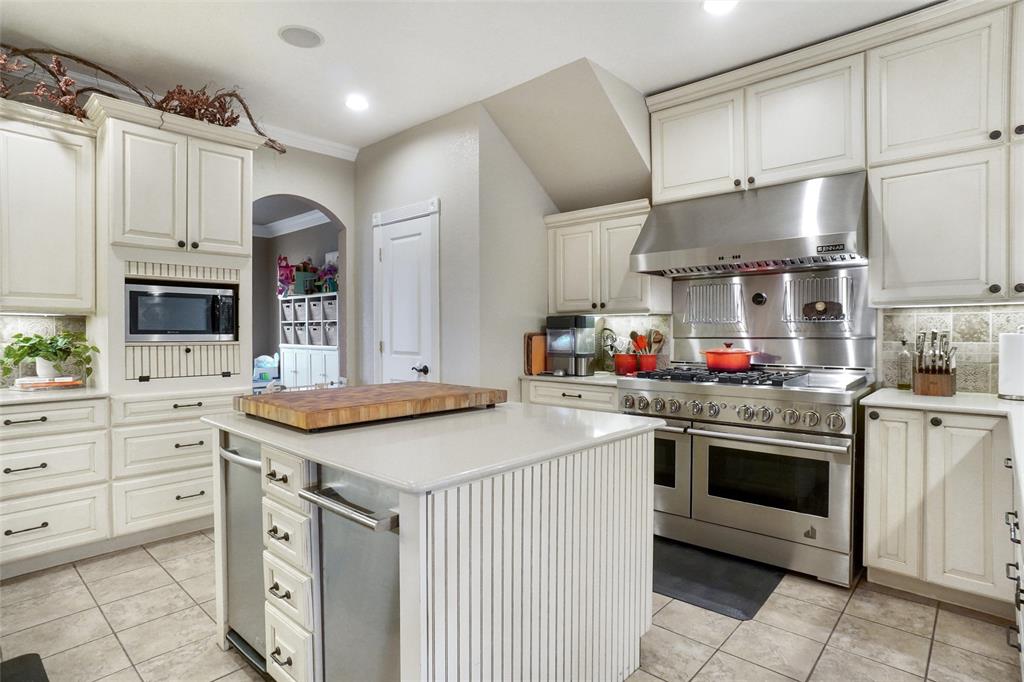 13340 John Day Road Haslet, TX 76052 - Photo 7 of 30 a kitchen with stainless steel appliances granite countertop a sink stove and cabinets