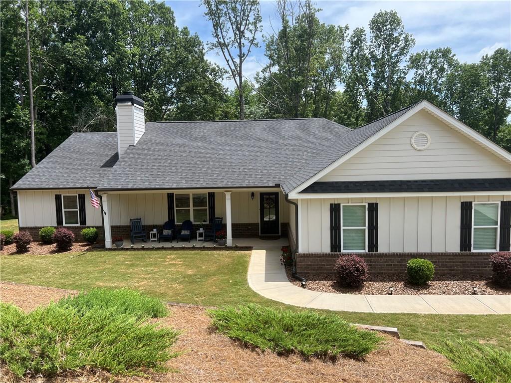 a front view of a house with a yard porch and outdoor seating